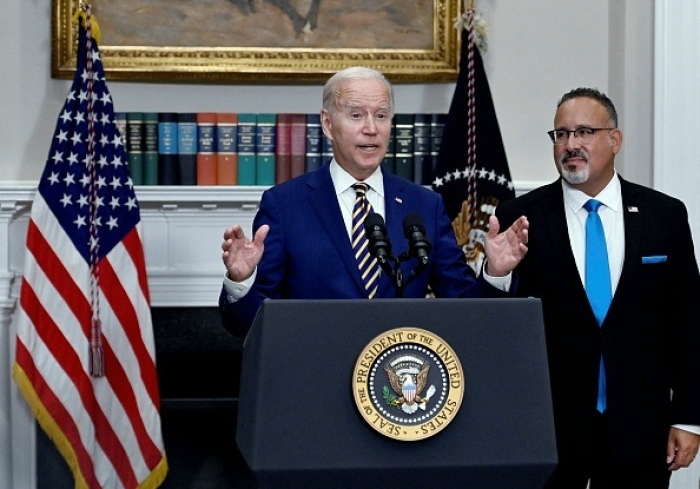 President Joe Biden announces student loan relief with Education Secretary Miguel Cardona on August 24, 2022 at the White House. (Photo by OLIVIER DOULIERY/AFP via Getty Images)