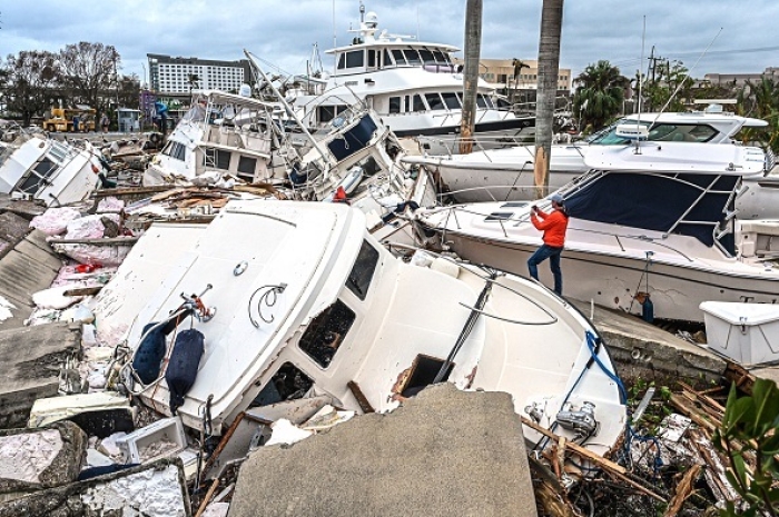 Boats damaged by Hurricane Ian in Fort Myers, Florida, on September 29, 2022. (Photo by GIORGIO VIERA/AFP via Getty Images)