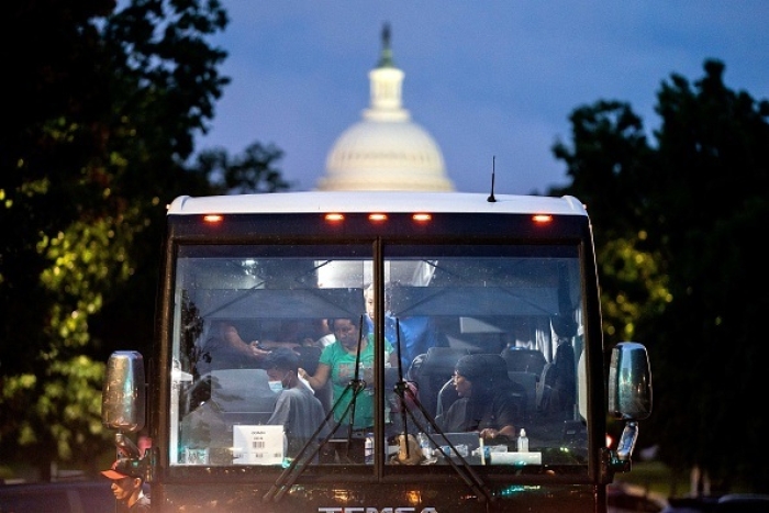 Migrants who crossed illegally into Texas are dropped off within view of the US Capitol building in Washington, DC, on August 11, 2022. (Photo by STEFANI REYNOLDS/AFP via Getty Images)