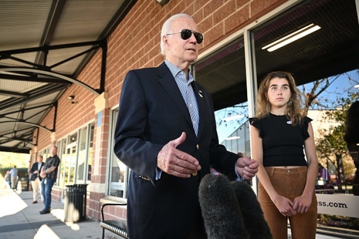 President Joe Biden, with his granddaughter Natalie Biden, speaks to the press after voting early in Wilmington, Delaware, on October 29, 2022. (Photo by MANDEL NGAN/AFP via Getty Images)