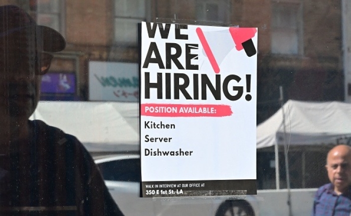 A &quot;We Are Hiring&quot; sign is posted in front of a restaurant in Los Angeles, California on August 17, 2022. There were 10.1 million job openings in this country on the last business day of August. (Photo by FREDERIC J. BROWN/AFP via Getty Images)