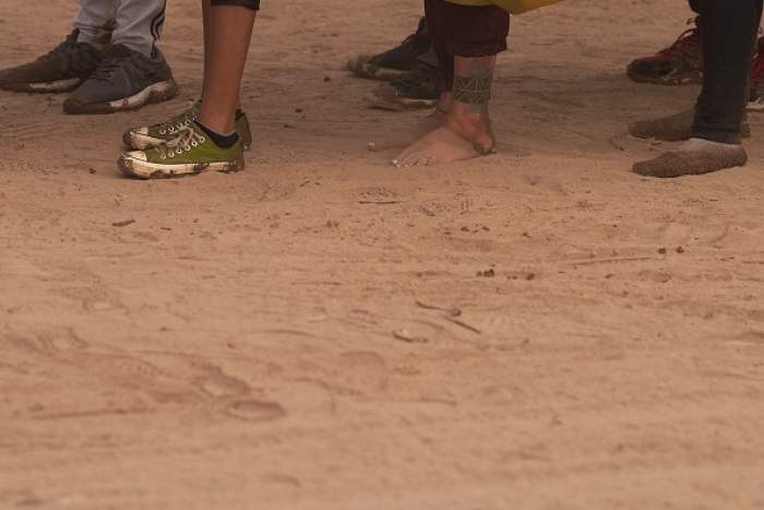 The feet of migrants are covered in dirt after they illegally crossed the US southern border with Mexico on October 9, 2022 in Eagle Pass, Texas. (Photo by ALLISON DINNER/AFP via Getty Images)