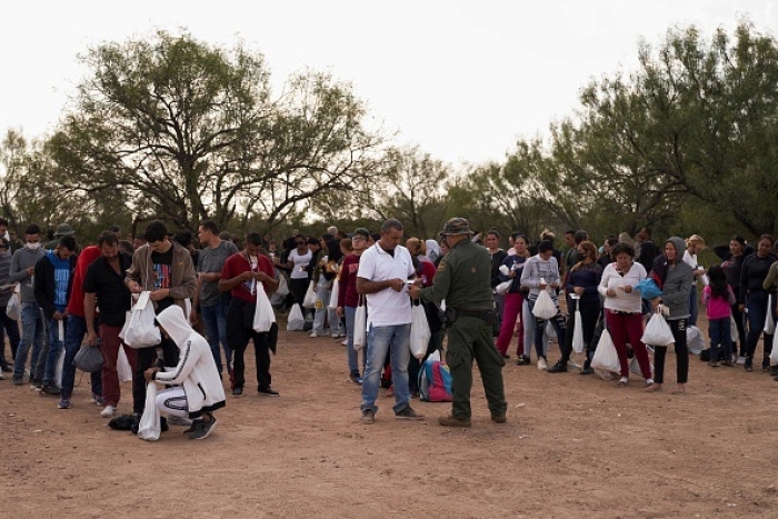Migrants are processed by US Border Patrol after they illegally crossed the US southern border on October 9, 2022 in Eagle Pass, Texas. (Photo by ALLISON DINNER/AFP via Getty Images)