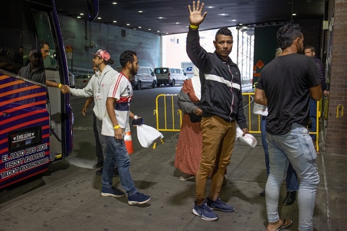 Multiple busloads of asylum-seekers arrive daily in New York City, where they receive a warm welcome despite the city's inability to handle the influx. (Photo by Andrew Lichtenstein/Corbis via Getty Images)