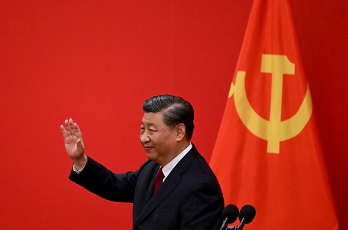China's President Xi Jinping waves after introducing the members of the Chinese Communist Party's new Politburo Standing Committee, the nation's top decision-making body, in the Great Hall of the People in Beijing on October 23, 2022. (Photo by NOEL CELIS/AFP via Getty Images)