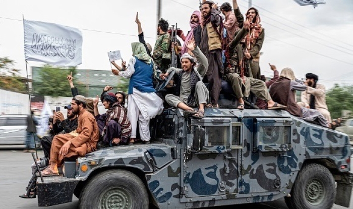 Taliban fighters celebrate near the U.S. Embassy in Kabul on August 15, 2022, one year after the country fell to the fundamentalist group. (Photo by Wakil Kohsar / AFP via Getty Images)