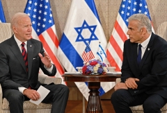 US President Joe Biden (L) holds a bilateral meeting with Israel's Prime Minister Yair Lapid at a hotel in Jerusalem on July 14, 2022. (Getty Images)  