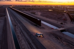 In an aerial view, border patrol agents park next to where what's left of the Colorado River after U.S. states have taken their allotment of water flows through the border fence to Mexico, in the distant right, on September 27, 2022 near Yuma, Arizona. (Photo by David McNew/Getty Images)